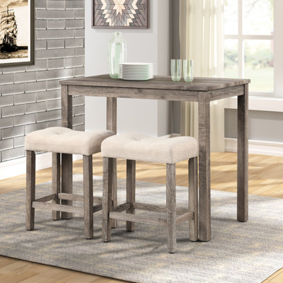 Table haute de salle à manger taupe en bois - Tabourets de bar rembourrés et structure stable. Disponible en 3 couleurs. Bois. Pieds en hévéa. Rembourrage en mousse à 2 boutons.