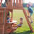 Backyard Discovery Woodland Cedar Wood Swing Set with Wave Slide, Clubhouse, Rock Wall, and Snack Bar Station