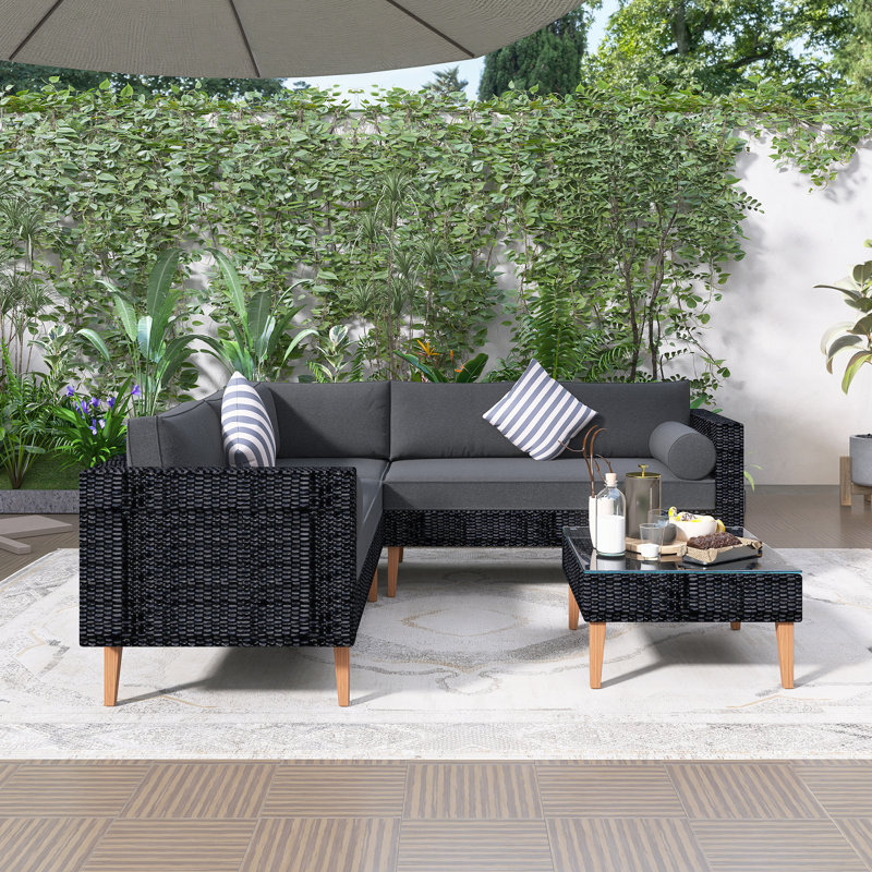 Ensemble de canapé d'extérieur en osier 4 pièces, ensemble de conversation pour patio avec coussins colorés, forme en L, table basse, deux coussins cylindriques, coussins gris et rotin noir