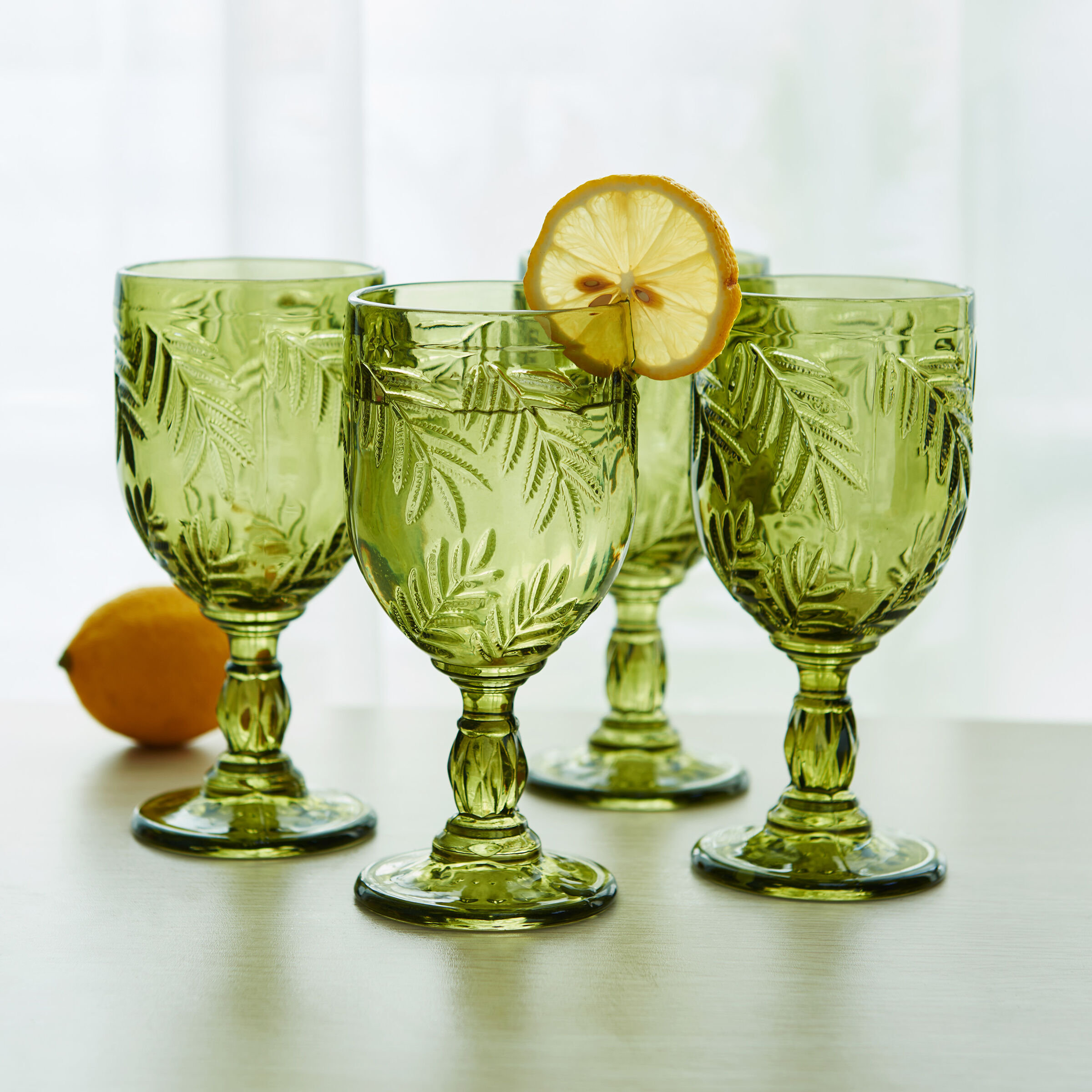 https://assets.wfcdn.com/im/90170066/compr-r85/2376/237626761/fitz-and-floyd-villa-palm-11-oz-wine-goblet-glasses-set-of-4-green.jpg