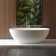 65"L x 29.5"W x 21.7"H Solid Surface Freestanding Oval Tub with Overflow and Drain
