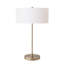 Lampe de table Mischa Slimline, style moderne, corps et base en acier laitonné vieilli, abat-jour cylindrique en lin blanc, hauteur 81 cm, variateur intégré.
