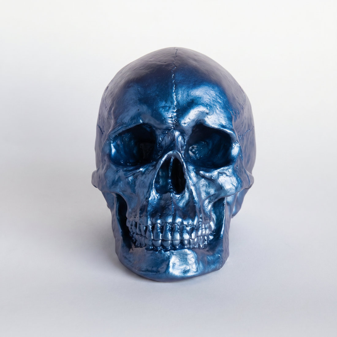 Muscogee Faux Human Skull Holiday Figurine, Metallic Blue
