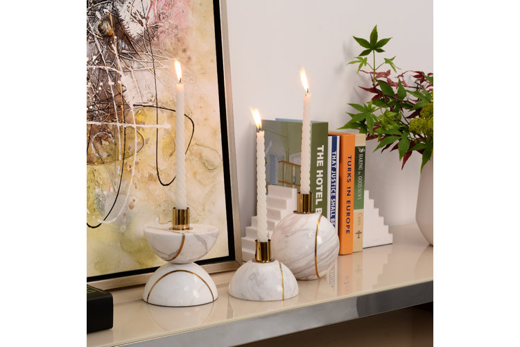Abstract marble candle holders with taper candles.