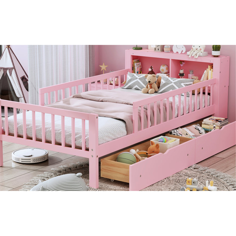 Lit simple rose avec base solide et options de rangement pour la tête de lit dans un compartiment de fabrication sécuritaire