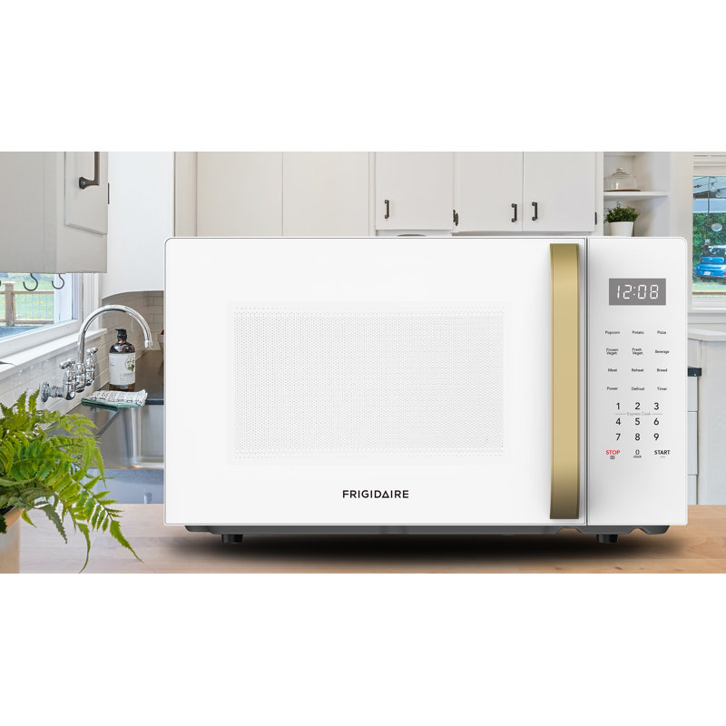 Frigidaire Pi. Four à micro-ondes de comptoir 900 watts avec 10 niveaux de puissance, 8 menus de cuisson automatique, dégivrage automatique, verrou de sécurité pour enfants, blanc