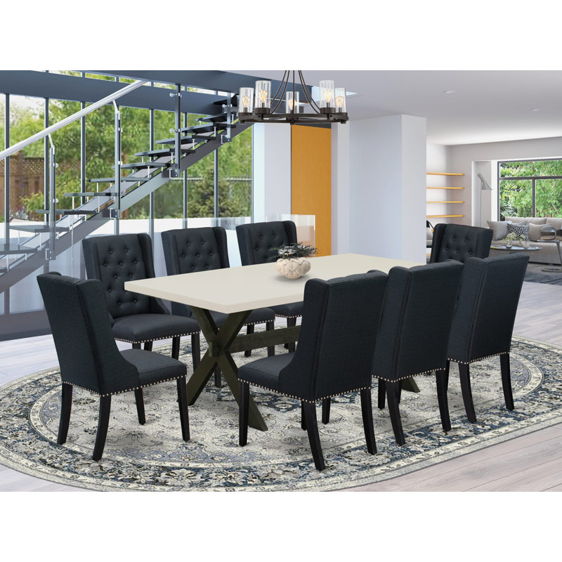 Cet ensemble de table de salle à manger moderne 9 pièces comprend une table de salle à manger rectangulaire avec des pieds en X et 8 chaises rembourrées en tissu de lin noir, avec une finition noire brossée.