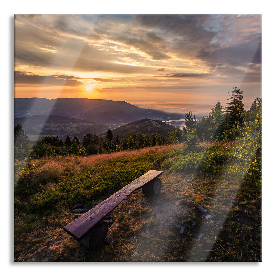 Glasbild Bank auf Berggipfel bei Sonnenuntergang