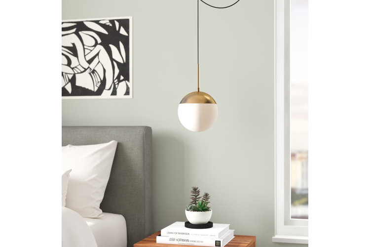 globe swag light hanging over a nightstand