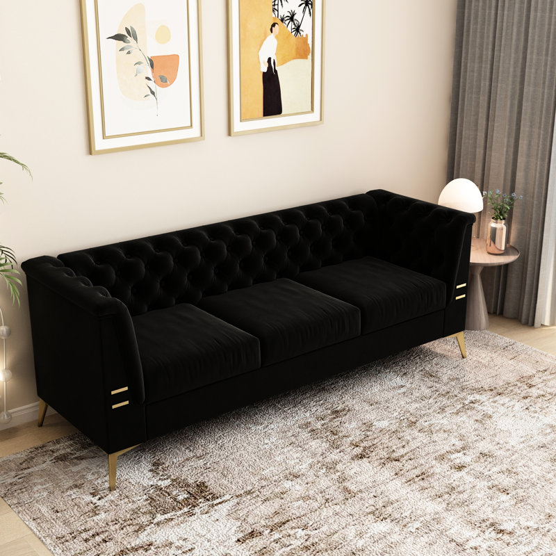 Velours noir avec des pieds dorés et un design élégant