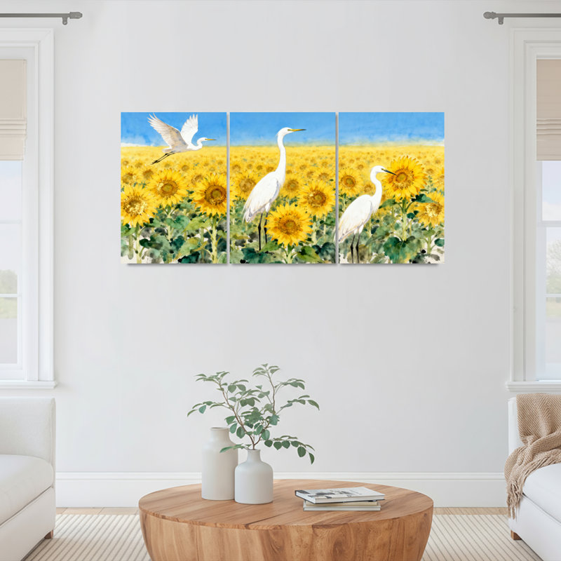 Ensemble de 3 tableaux sur toile représentant un champ de tournesols avec des hérons blancs, H 18 po x l 36 po