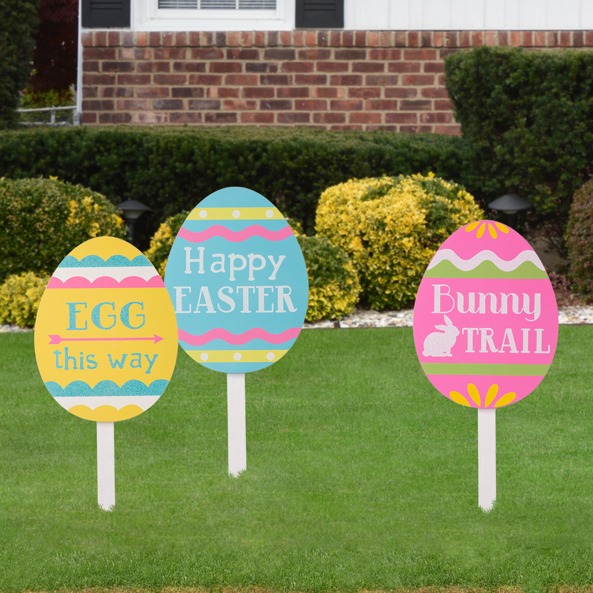 Three Easter egg decorations in a lawn