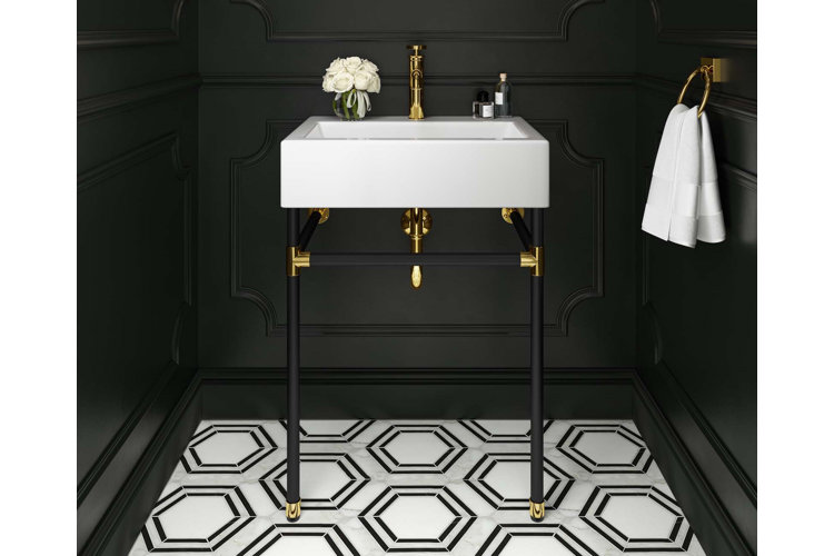 High contrast powder room with black walls, a white sink, and white and black Art Deco–inspired floor tiles.