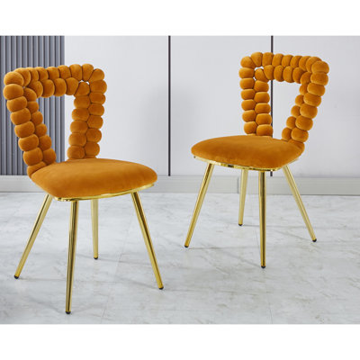 Élégante chaise de chambre à coucher en orange et or avec des pieds d'écurie souples et une structure de salon élégante