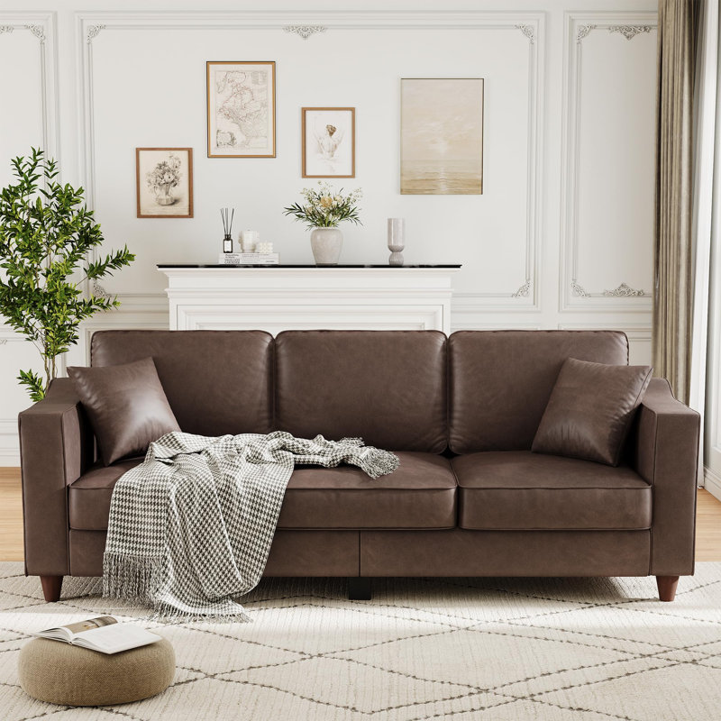 Canapé 3 places en similicuir brun foncé - accoudoirs larges, sièges profonds, pieds en bois, comprend 2 coussins décoratifs, idéal pour le salon ou le bureau