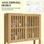 Armoire de rangement en bambou au-dessus de la toilette avec portes à lattes et tablette réglable