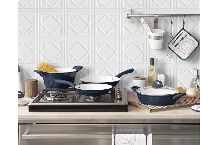 Skillet dimensions a set of skillets on a stove with a stock pot in a kitchen with a white tile backsplash
