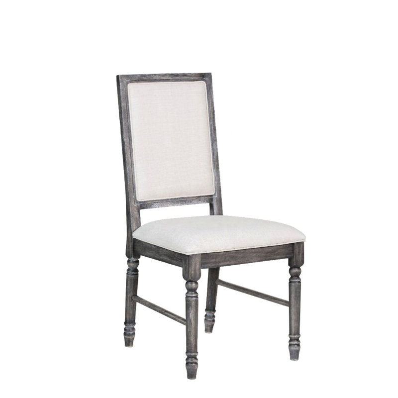 Deux chaises d'appoint classiques, fini gris, revêtement en lin crème, structure en bois avec pieds tournés, dossier et siège rembourrés, pour une esthétique raffinée dans la salle à manger.