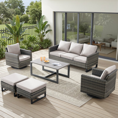 7 Piece Outdoor Wicker Seating Set: Sofa, 2 Swivel Chairs, 2 Ottomans & Side Table