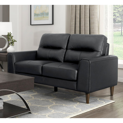 Cuir noir avec coussins en mousse à haute densité, structure en bois massif et en contreplaqué, largeur du produit de 34,5 po, accoudoirs à grain supérieur noir, pieds à finition brune, hauteur du siège de 18 po, style moderne polyvalent