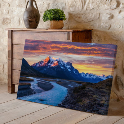 Canvas A Majestic Mountain Range Towers In The Background With Sharp Wall Art Jagged Peaks Capped In Glistening Snow Reflecting The Canvas Wall Art