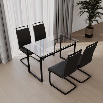 Ensemble de table de salle à manger pour quatre personnes, combinant table et chaises avec pieds en métal et plateau en verre trempé pour les espaces de salle à manger modernes