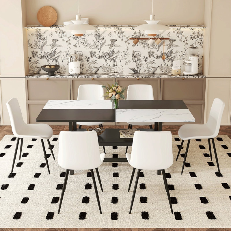 Table And Chair Set. Black Spliced Dining Table With Storage Function In The Middle Of The Table Legs.Paired With White Artificial PU Chairs With Curved Widened Cushion Design.