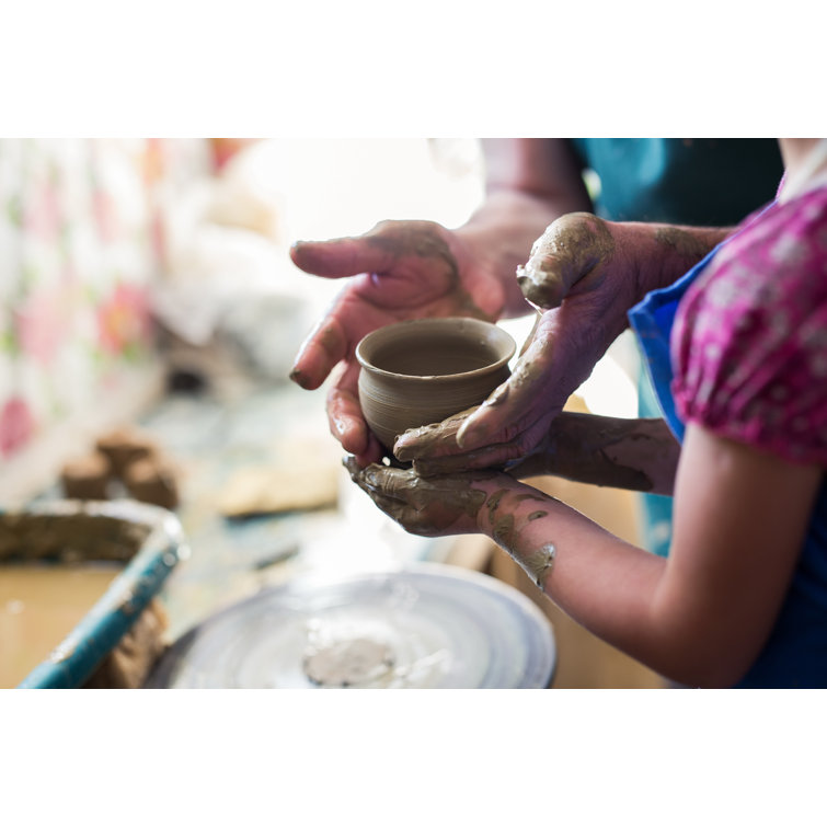 Girl Making A Clay Bowl on Sculpting Wheel Ebern Designs Size: 8 H x 12 W x 1.25 D
