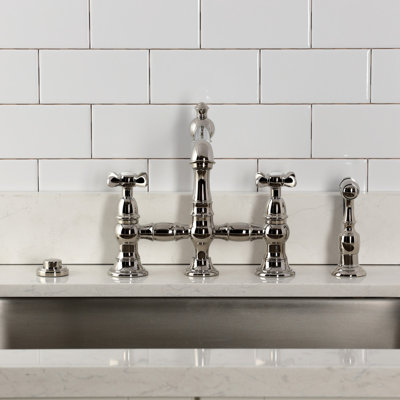 Kingston Brass Essex Two-Handle 4-Hole Deck Mount Bridge Kitchen Faucet with Brass Side Sprayer
