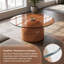 Deux tables basses gigognes - une grise avec un plateau en verre et une table d'appoint ronde brune - parfaites pour le salon ou le bureau-105226042