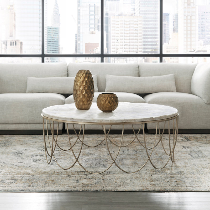 Round Stone Top Cocktail Table With Decorative Metal Base