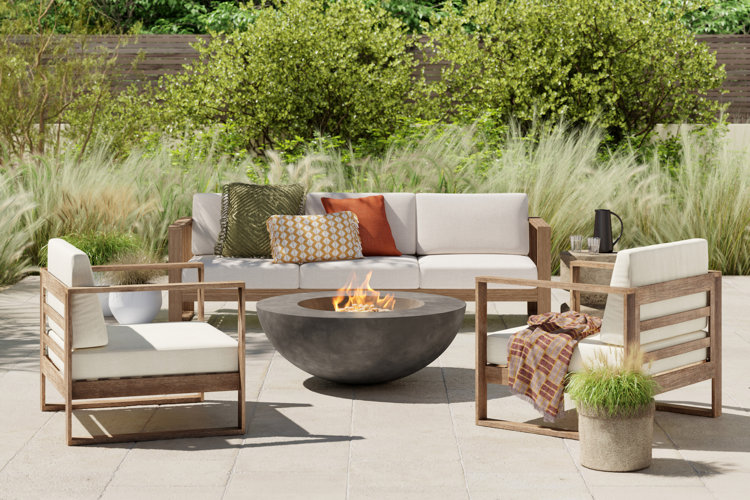 round concrete fire pit in the center of a wood patio furniture set