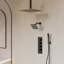 Matte black thermostatic shower system with ceiling-mounted rainfall head, wall-mounted head, handheld sprayer, and control panel.