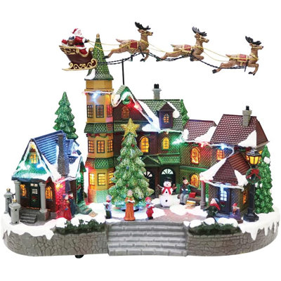 Moments in Time's 12.8”H Animated Santa Riding Sleigh Flying Over Town Centre