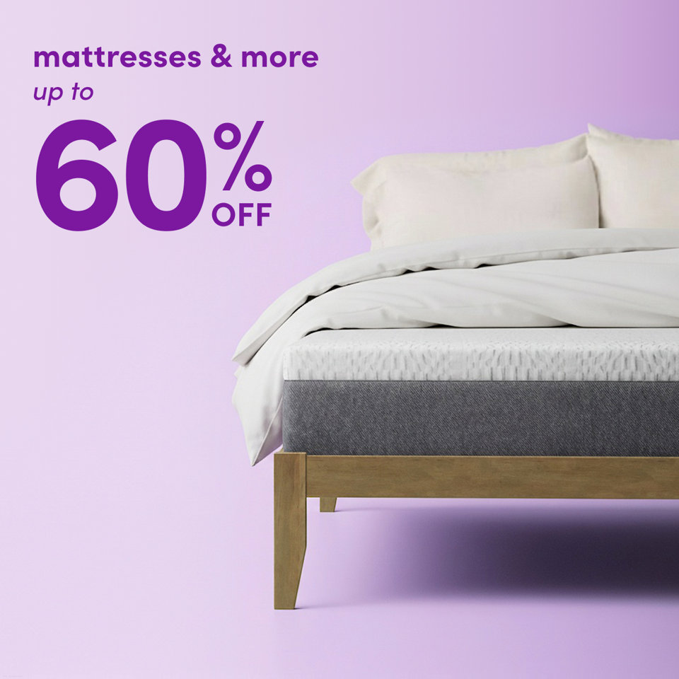 Mattresses and more on sale for up to 60 percent off, featuring a bed with a white mattress and bedding against a light purple background.