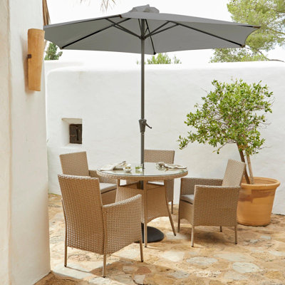 Dubose 4 - Person Wicker Patio Dining Set with Round Table , Cushions Included