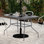 Table de patio de qualité commerciale avec plateau en verre trempé avec trou pour parasol et structure en tube d'acier