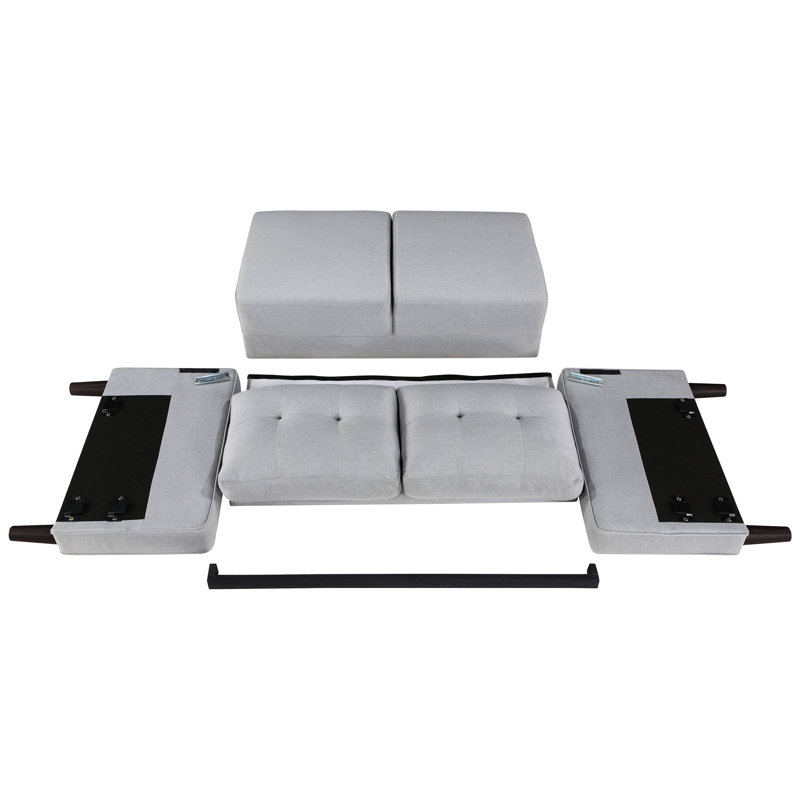 Canapé compact gris rembourré, silhouette classique et pieds fuselés, idéal pour les petits appartements. Accoudoirs et dossier carrés, confort optimal.