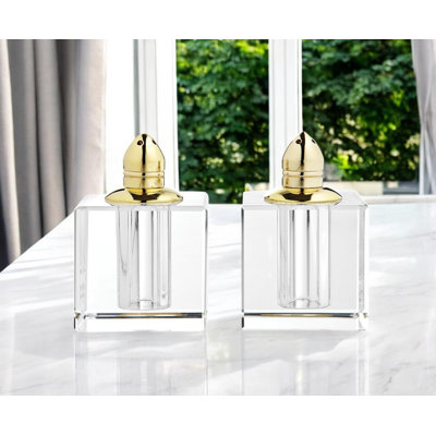 Ensemble de deux poivrières en cristal transparent et doré