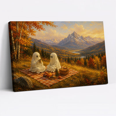 Deux fantômes pique-niquant avec des citrouilles et une toile murale d'Halloween enneigée