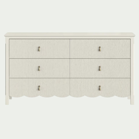 White six-drawer double dresser with a ribbed texture, brass teardrop pulls, and a scalloped bottom edge.