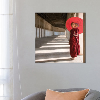 Buddhist Monk With Red Umbrella, Bagan, Myanmar by Jan Becke - Wrapped Canvas Print