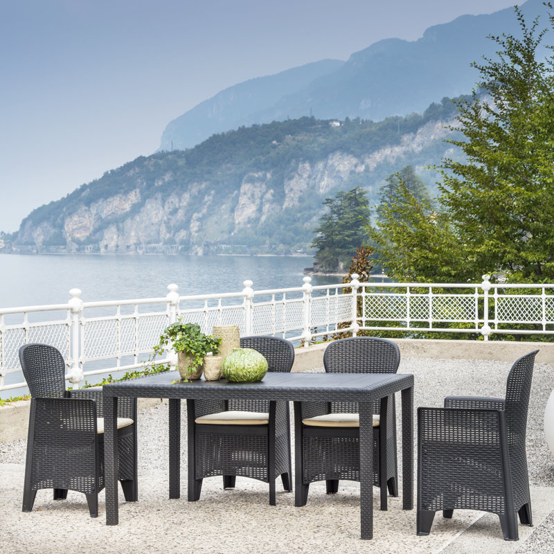 Henryville 4 - Person Patio Dining Set Rectangular Table with Cushions Included