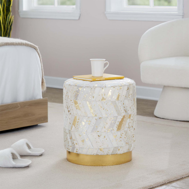 Stylish Leather Ottoman With Gold Metal Base And Splatter Accents For Glam Interior Design