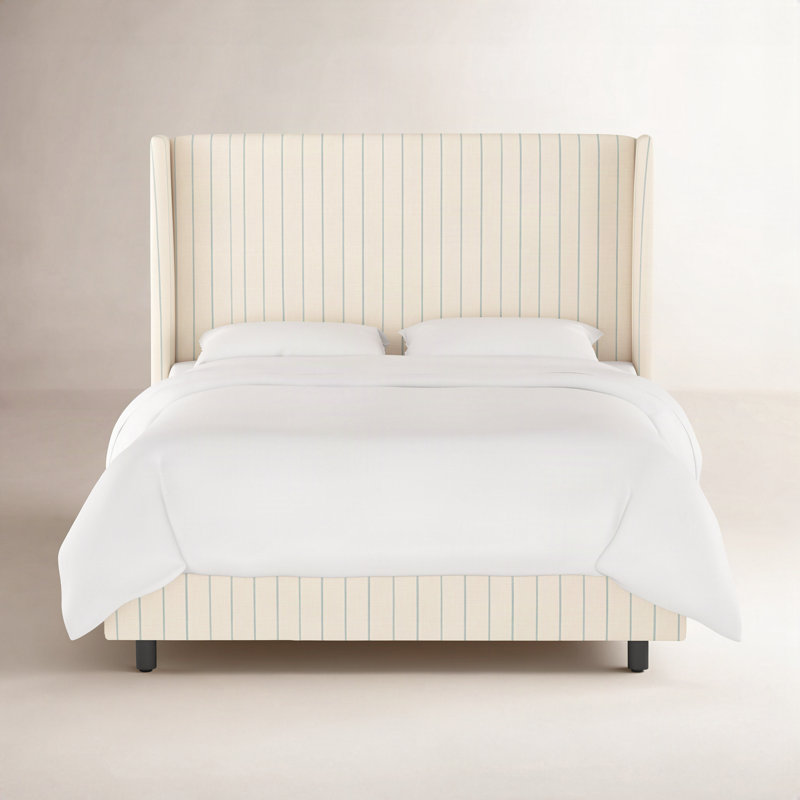Tilly upholstered bed in beige with blue vertical stripes and a wingback headboard.