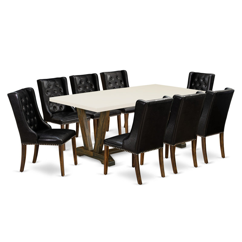 Cet ensemble de table de salle à manger 9 pièces comprend une table rectangulaire en bois avec pieds en V et 8 chaises rembourrées en similicuir noir, en lin brossé blanc.