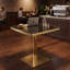 Table de bistrot carrée moderne de 61 cm (24 po) en faux marbre noir, idéale pour les petits espaces. Plateau avec revêtement UV, bordure en acier inoxydable doré et pied central. Facile à nettoyer.