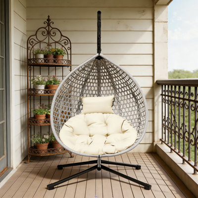 Sturdy Hammock Chair with Stand, Durable Rattan Weave and Removable Cushion for Indoor Outdoor Use.