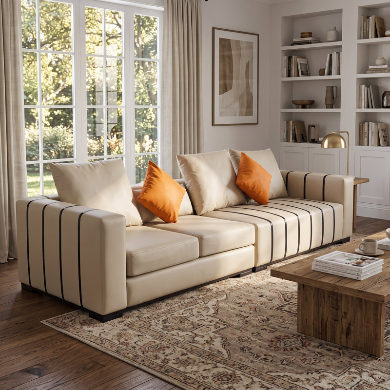  Wrought Studio™ 118" Modern Oversized Cream Faux Leather Sofa with Black Striped Details and Toss Pillows