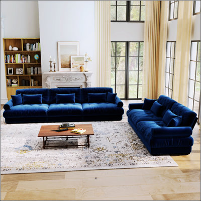Un ensemble de canapé modulaire combinant un canapé deux places et un canapé trois places, en tissu de velours, avec coussins décoratifs, coussins lombaires et accoudoirs ronds. Disponible en bleu, idéal pour les salons, les appartements et